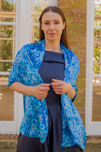 a turquoise floral printed scarf worn over a gown