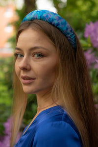 model wearing elegant turquoise floral silk satin padded headband sustainably hand-crafted in UK