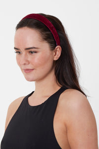 model wearing elegant burgundy velvet headband with a soft, luxurious finish, perfect for adding a touch of sophistication to any outfit.