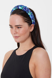 A delicate blue and cobalt printed silk padded headband worn elegantly by a model