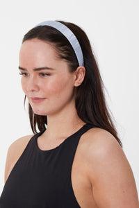 A subtle and elegant silk dusty blue headband that is versatile hand-made in London