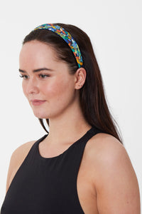 Model wearing a unique printed silk bamboo headband worn by a model that can worn daily