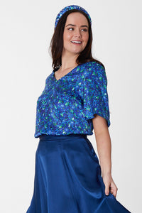 An Isabel Manns reversible v-neck silk satin top with elbow length sleeves in blue floral print.