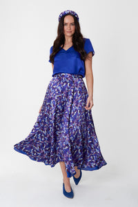 Model wearing reversible voluminous a-line midi silk satin vibrant cobalt skirt, worn with matching padded headband and v-neck cobalt Eleanor Top.