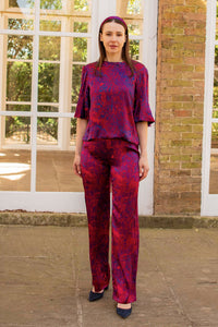 a front view of a model wearing our fire ocean trousers