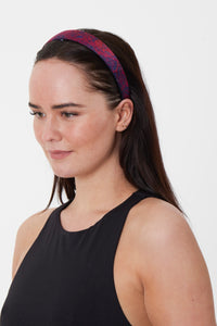 A marble red silk printed headband worn by a model