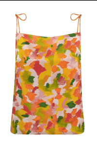 Reversible silk satin slip top with v-back neckline in dotted orange print.