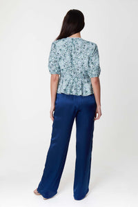 Back view of high waisted narrow fit silk viscose palazzo pants in textured navy.