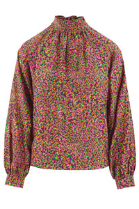 Halter neck silk bamboo top with long raglan sleeves with tie collar in dotted orange print.