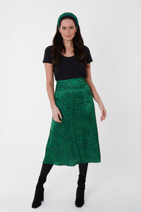 Model wearing vibrant green silk printed Isabel Manns narrow a-line midi skirt with wide waistband, worn with matching padded headband and black t-shirt.