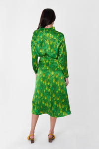 Back view of model wearing a colourful green and yellow silk printed Isabel Manns narrow a-line midi skirt with wide waistband, worn with matching Lisa Shirt.
