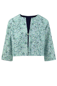 An Isabel Manns reversible box shaped cropped pale green silk satin print jacket, with pearl button.