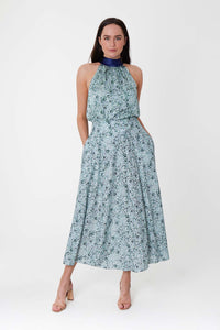 Model wearing a-line midi silk bamboo pale green printed skirt, worn with matching halter neck Sophie Top.