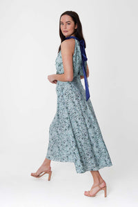 Side view of Model wearing a-line midi silk bamboo pale green printed skirt, worn with matching halter neck Sophie Top.