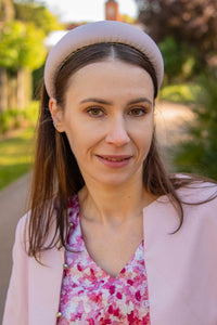 a pale pink padded headband worn by model to match her outfit