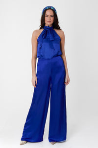Model wearing an Isabel Manns reversible high waisted silk satin palazzo pants in cobalt, worn with matching halter neck Sophie Top in cobalt.