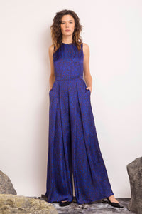 An Isabel Manns sleeveless wide leg silk cotton jumpsuit and matching belt that comes in a vibrant green print.
