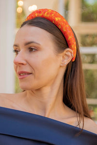 pixelated afterglow orange printed padded headband on model