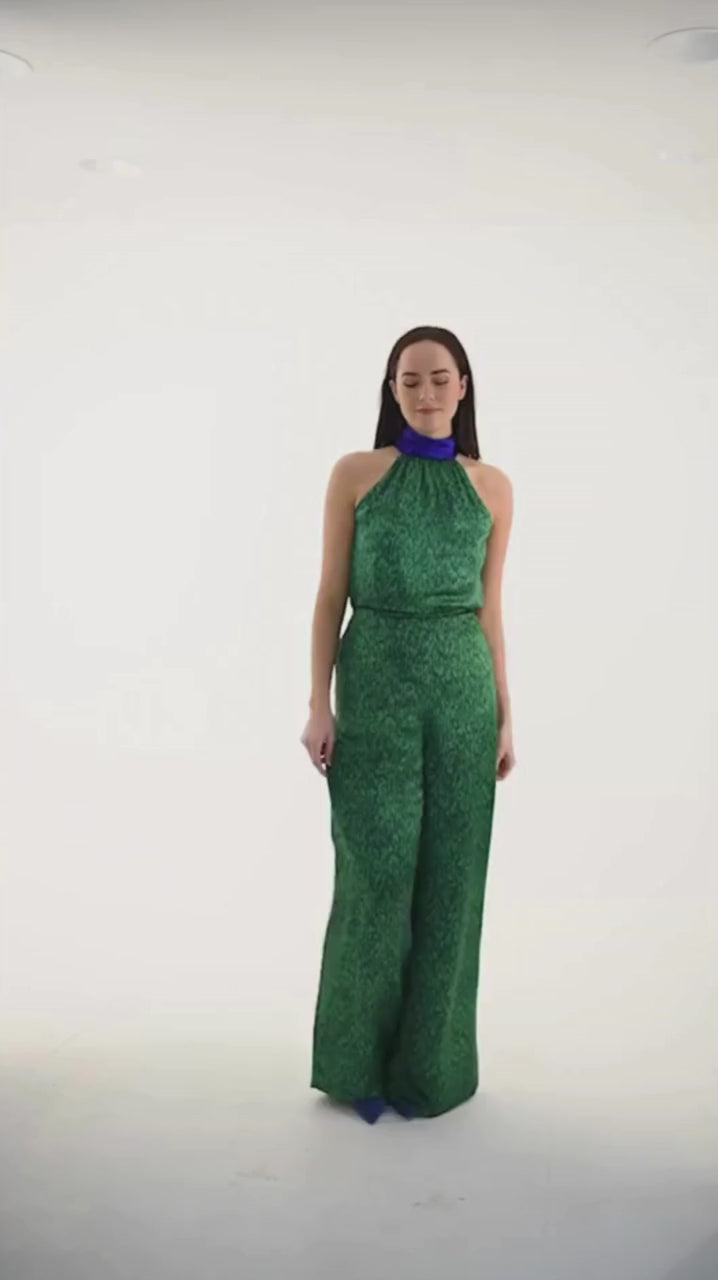 Video of model wearing an Isabel Manns reversible high waisted silk satin palazzo pants in vibrant green print, worn with matching halter neck Sophie Top in Flecked Emerald.