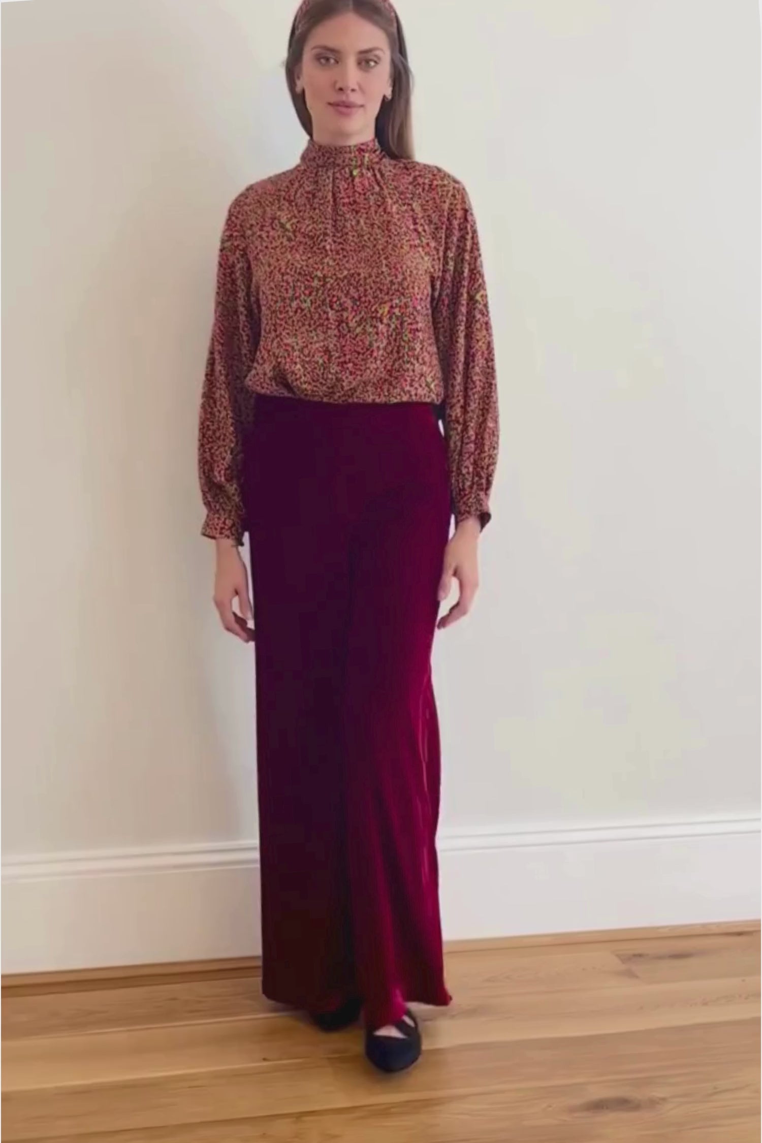 Video of Model wearing high waisted palazzo pants in burgundy velvet, worn with long sleeved Hannah top in Neon Light and matching headband.