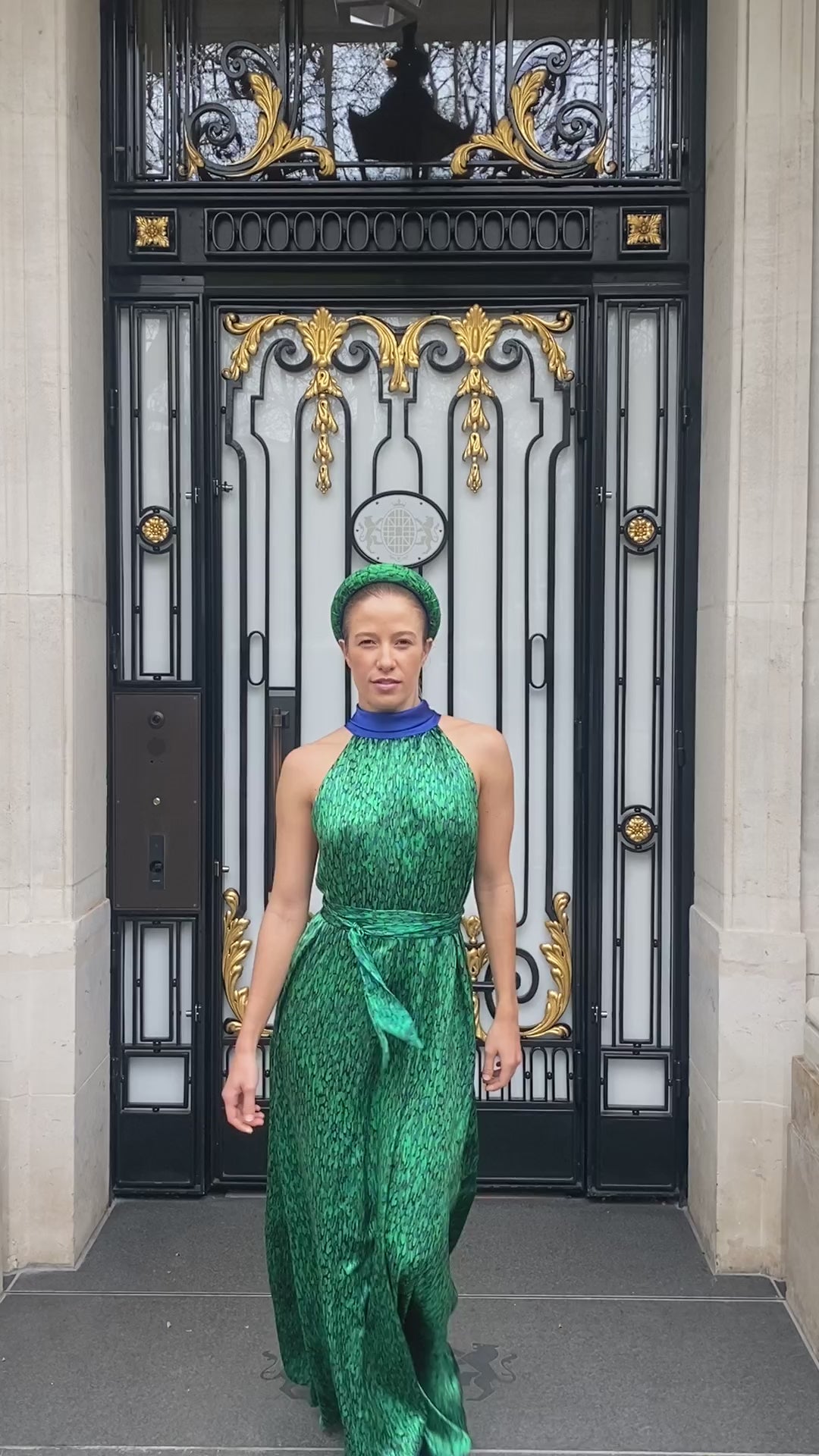 a video showing our best selling green printed and cobalt reversible silk satin halter neck dress in motion by a model