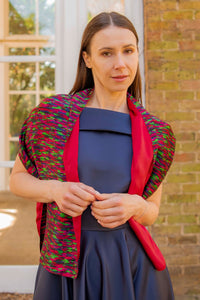 a reversible colourful scarf being worn over a gown by a model