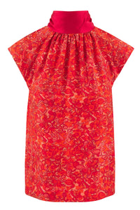 Reversible halter neck silk satin top with tie collar and cap sleeves in vibrant red print.