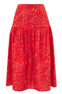 An Isabel Manns a-line midi silk bamboo skirt with an extra wide waistband and gathered detail from hips down in vibrant red swirl print.