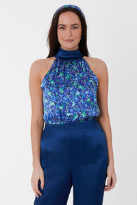An Isabel Manns reversible halter neck silk satin top with tie collar in vibrant blue print.