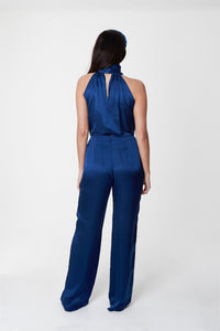 A back view of reversible halter neck silk satin top with tie collar in navy with matching navy Georgia trousers.