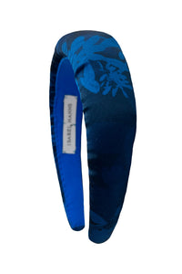 A teal printed silk satin padded headband that is sustainable and stylish