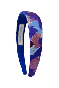 a silk headband comprising of a patchwork print made of purple shades