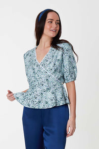 An Isabel Manns reversible wrap peplum silk bamboo top with elbow length sleeves in sage green print.