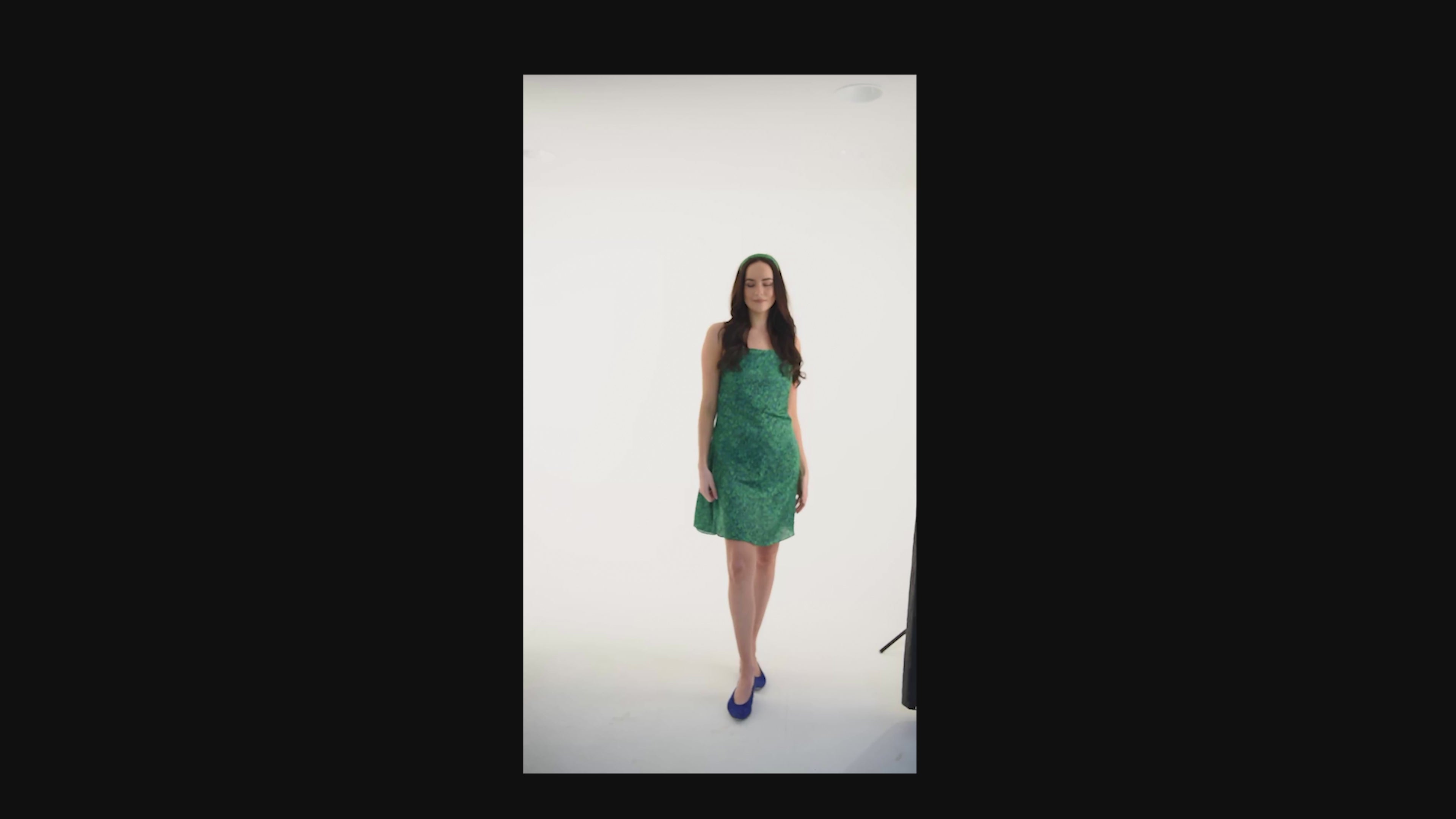 a video of a green print slip dress style worn by a model made in london